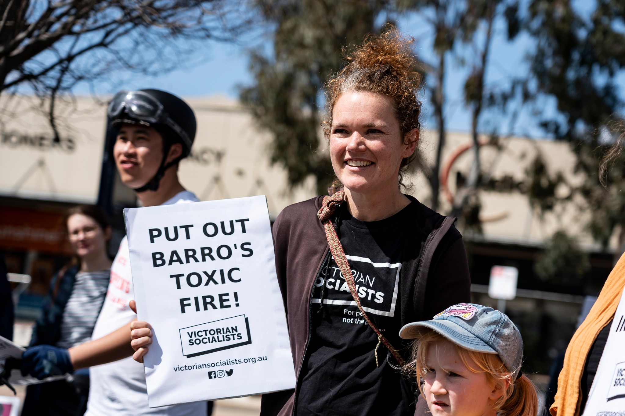 A woman holds a placard at the rally