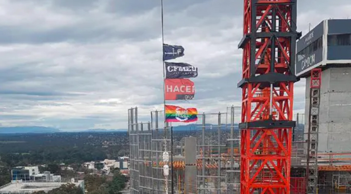 A rainbow flag flies over a major construction site in Melbourne in the lead-up to the 2017 marriage equality plebiscite